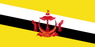 The flag of Brunei has a yellow field with two adjoining diagonal bands of white and black that extend from the upper hoist side of the field to the lower fly side. The red emblem of Brunei is centered on the field.